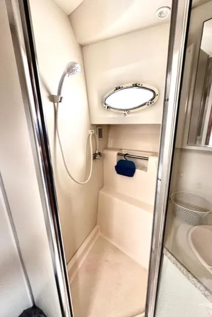 Slide: The Image of 2000 Silverton 392 Motor Yacht bathroom with shower and porthole window. - 32