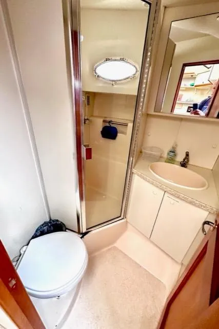 Slide: The Image of 2000 Silverton 392 Motor Yacht bathroom with shower, sink, and toilet. - 33