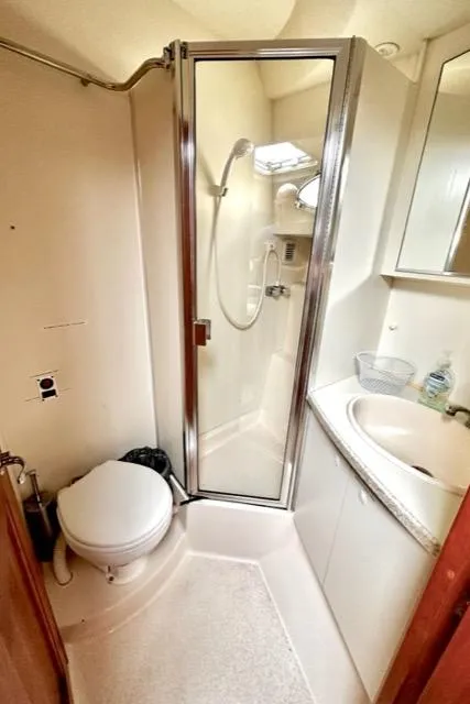 Slide: The Image of 2000 Silverton 392 Motor Yacht bathroom with shower, toilet, and sink. - 35