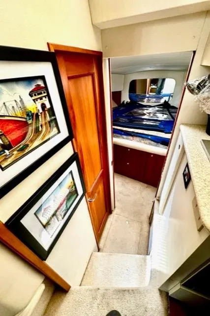 Slide: The Image of Interior of a 2000 Silverton 392 Motor Yacht with framed artwork and a cozy cabin. - 36