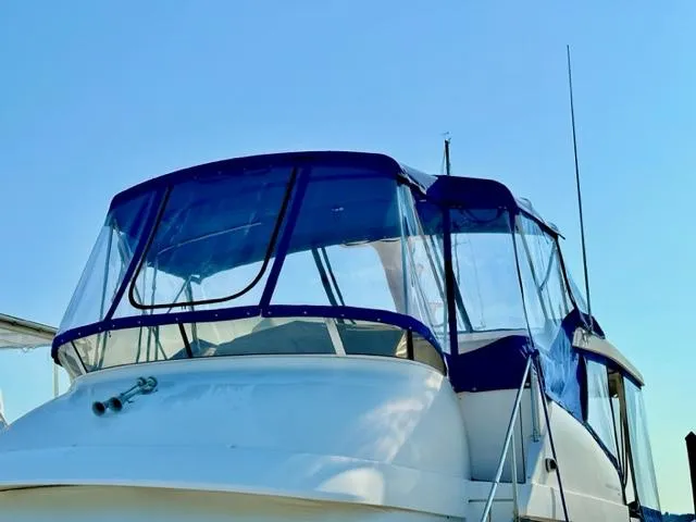 Slide: The Image of 2000 Silverton 392 Motor Yacht with blue canopy. - 4