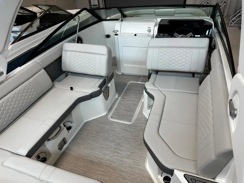 Slide: The Image of 2023 Sea Ray SDX 250 boat interior with luxurious seating and modern design. - 13