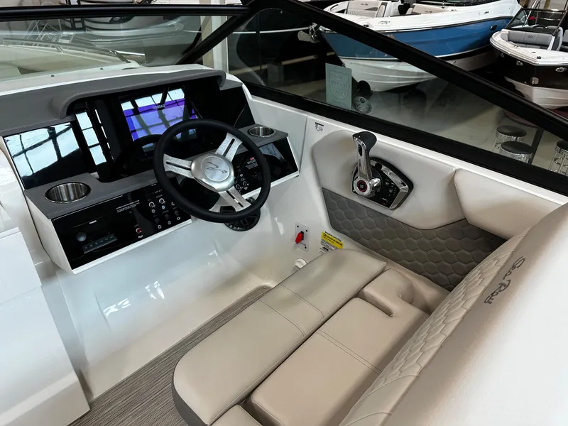 Slide: The Image of 2023 Sea Ray SDX 250 helm with modern steering wheel and control panel. - 15