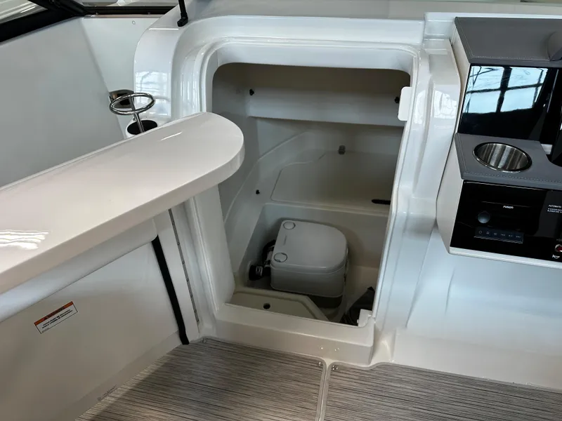 Slide: The Image of 2023 Sea Ray SDX 250 boat interior with compact marine toilet. - 18