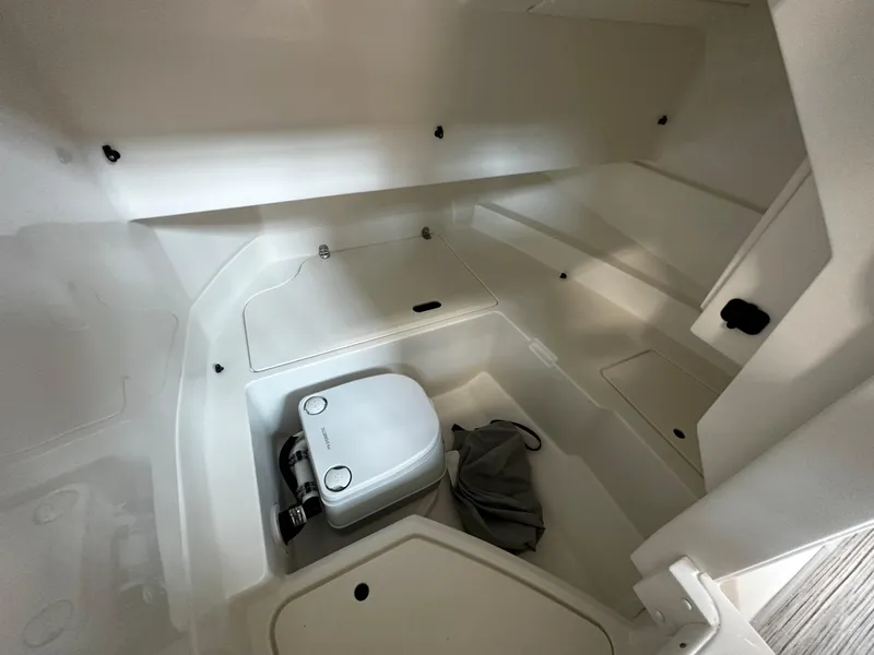 Slide: The Image of 2023 Sea Ray SDX 250 interior cabin with compact marine toilet. - 19