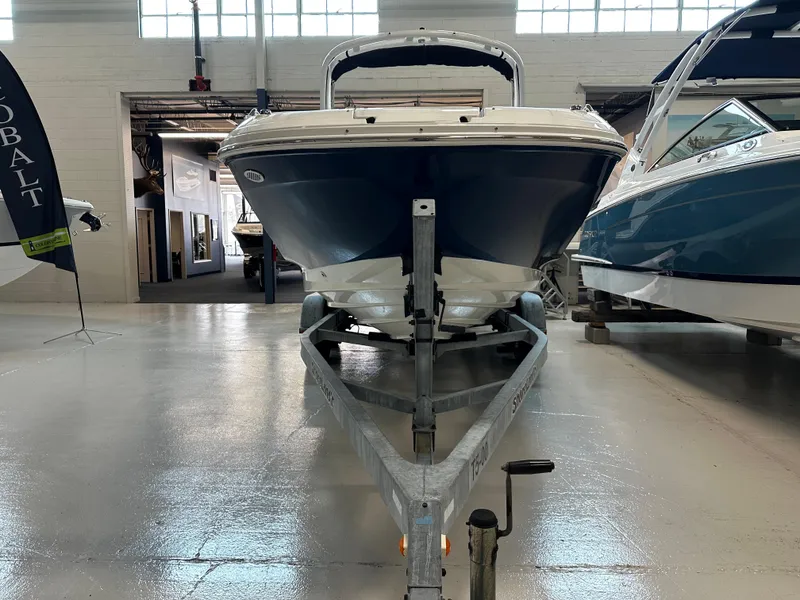 Slide: The Image of 2023 Sea Ray SDX 250 boat on trailer in showroom. - 2