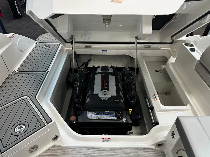Slide: The Image of 2023 Sea Ray SDX 250 boat engine compartment with open hatch, showcasing the engine. - 23