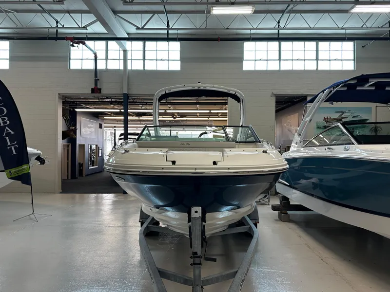 Slide: The Image of 2023 Sea Ray SDX 250 boat displayed indoors on a trailer. - 3