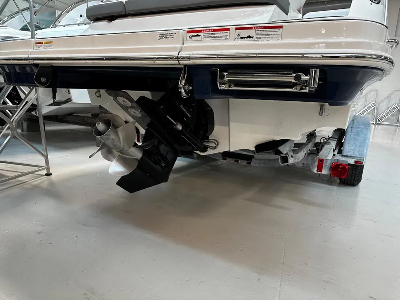 Slide: The Image of 2023 Sea Ray SDX 250 boat stern with propeller and trailer in showroom. - 5