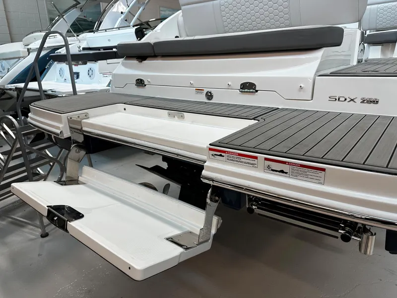 Slide: The Image of 2023 Sea Ray SDX 250 boat with extended swim platform and seating area. - 7