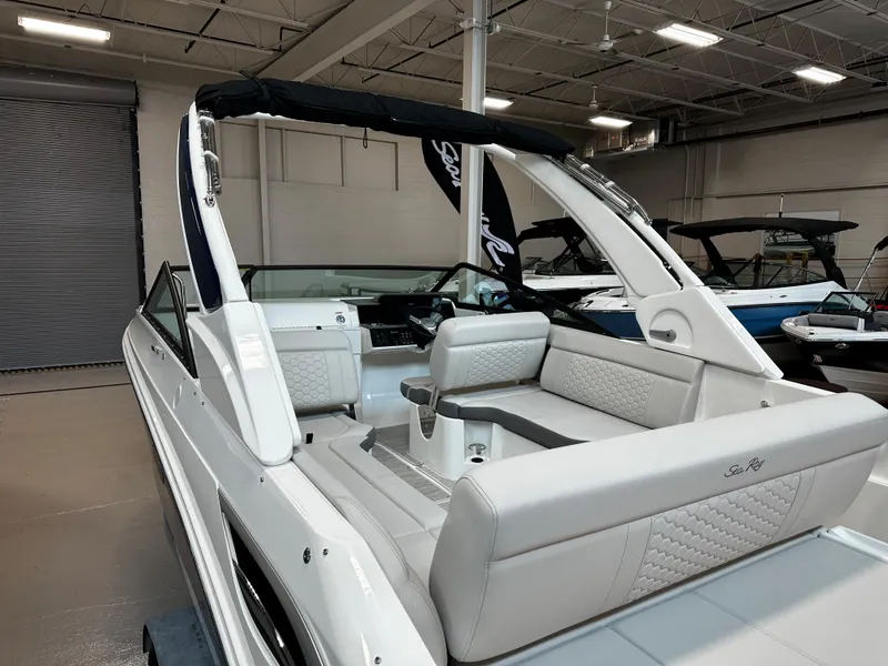 Slide: The Image of 2023 Sea Ray SDX 250 boat with sleek design and spacious seating in showroom. - 9
