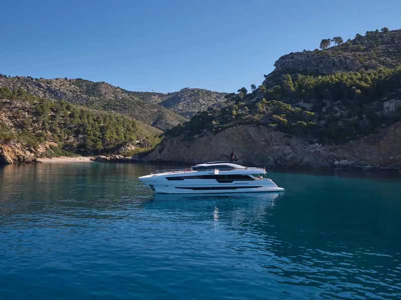 Slide: The Image of Luxury 2023 Astondoa 110 Century yacht in a serene coastal bay. - 4