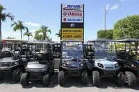 Slide: The Image of 2017 Yamaha Boats GP1800 displayed among golf carts at dealership. - 28