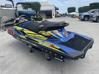 Slide: The Image of 2017 Yamaha GP1800 jet ski in blue and yellow, parked outdoors. - 7