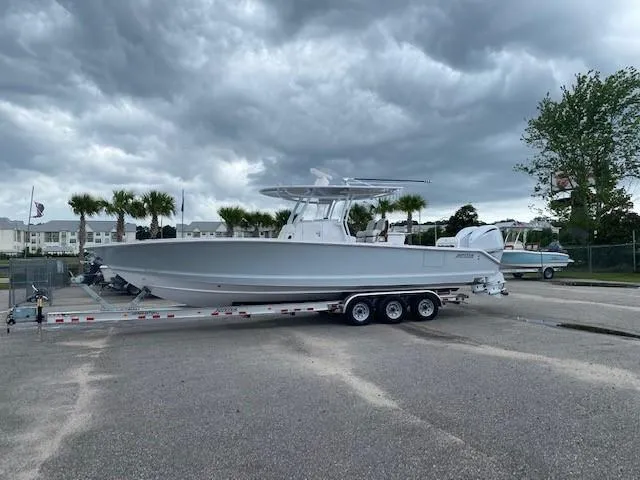 Slide: The Image of 2023 Jupiter 32 boat on a trailer under cloudy skies. - 0