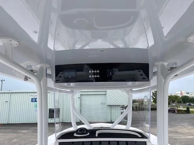 Slide: The Image of 2023 Jupiter 32 boat console with overhead electronics and storage compartments. - 5