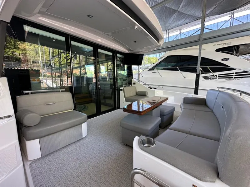 Slide: The Image of 2019 Tiara Yachts C53 interior lounge with modern seating and table. - 10