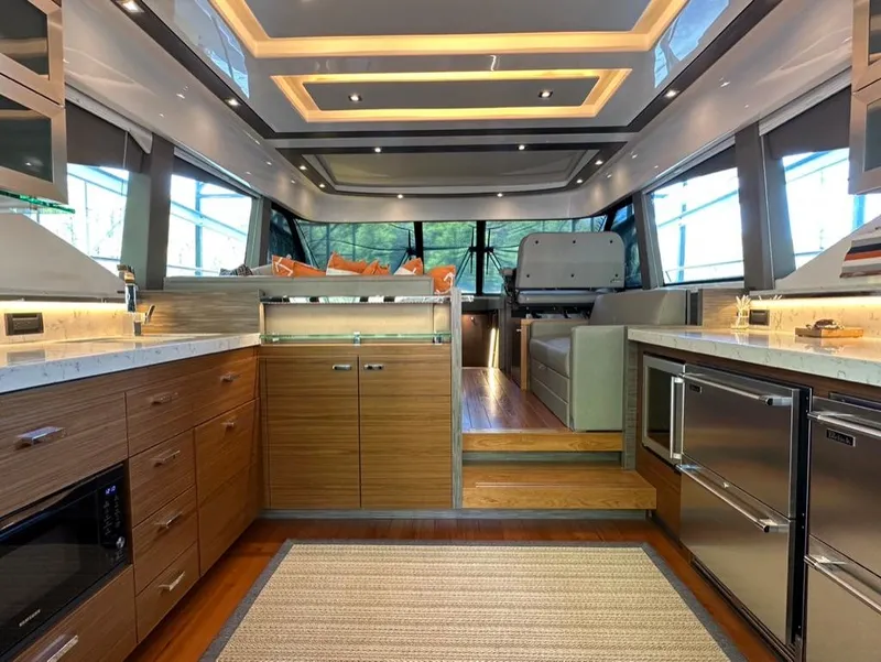 Slide: The Image of Luxurious interior of 2019 Tiara Yachts C53 with modern kitchen and seating area. - 12