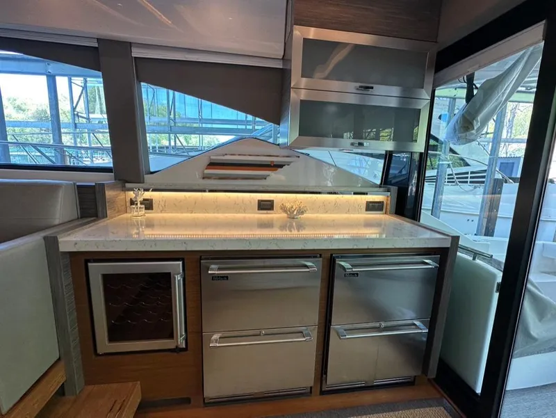 Slide: The Image of Modern kitchen area in 2019 Tiara Yachts C53 with stainless steel appliances. - 13