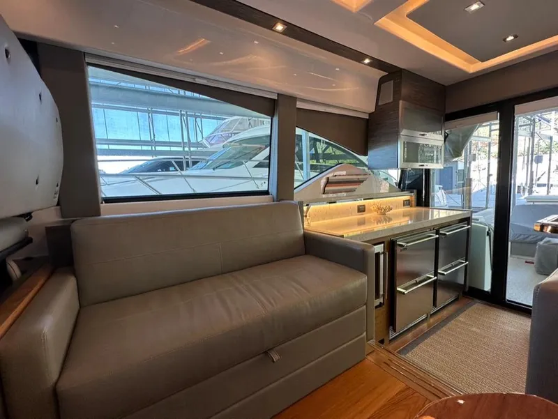 Slide: The Image of Interior of 2019 Tiara Yachts C53 with modern furnishings and large windows. - 16