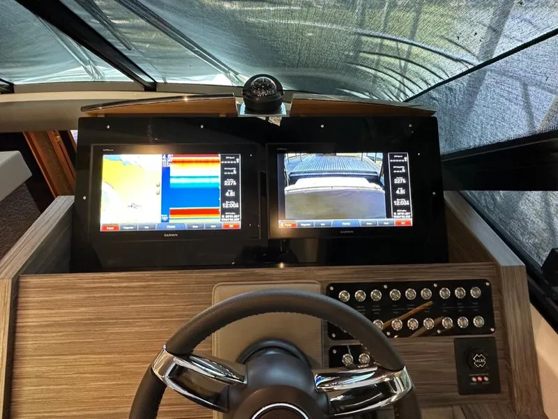Slide: The Image of 2019 Tiara Yachts C53 helm with dual navigation screens and control panel. - 20