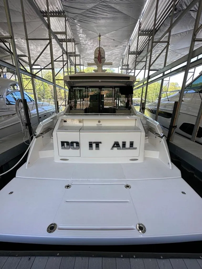 Slide: The Image of 2019 Tiara Yachts C53 docked in a covered marina. - 8