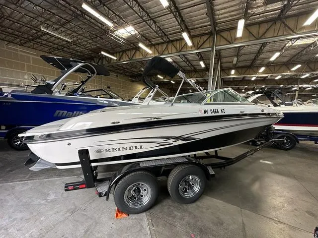 Slide: The Image of 2011 Reinell 207 LS boat on trailer in indoor storage facility. - 3