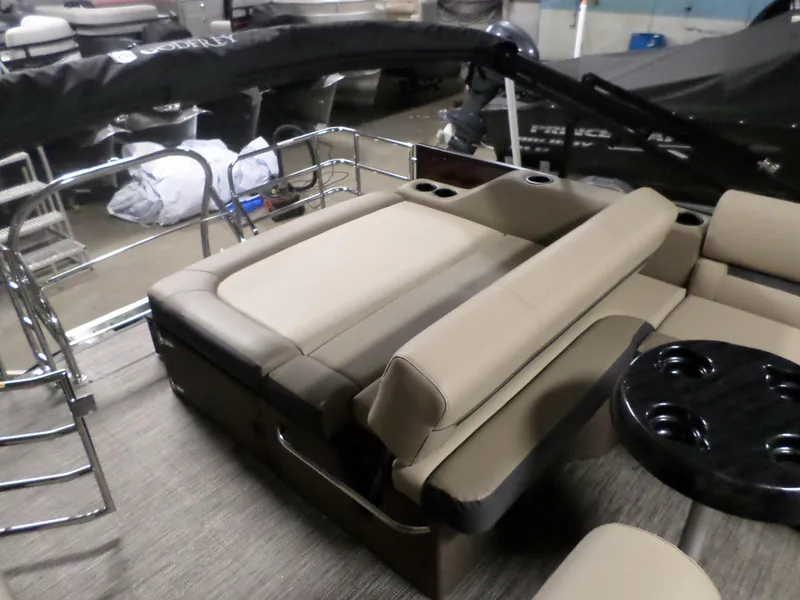 Slide: The Image of 2023 Godfrey Sweetwater 2486SFL pontoon boat interior with beige seating and black table. - 6