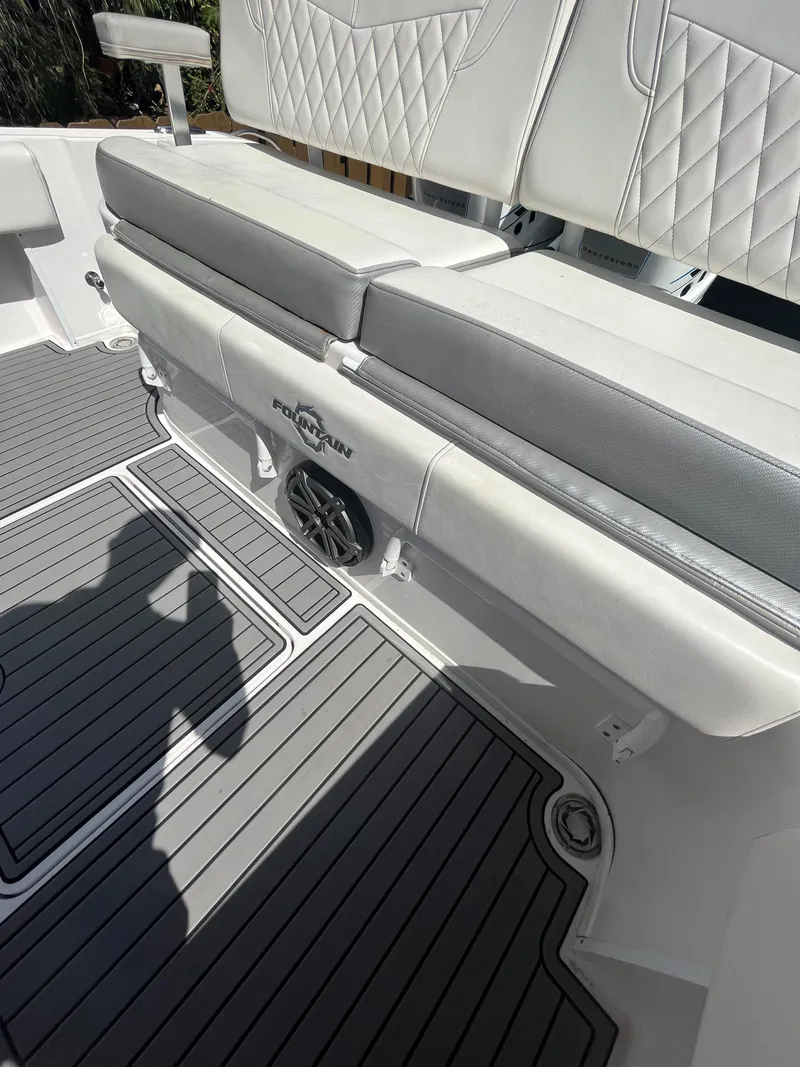 Slide: The Image of 2018 Fountain 34 CC boat interior with cushioned seating and speaker. - 11