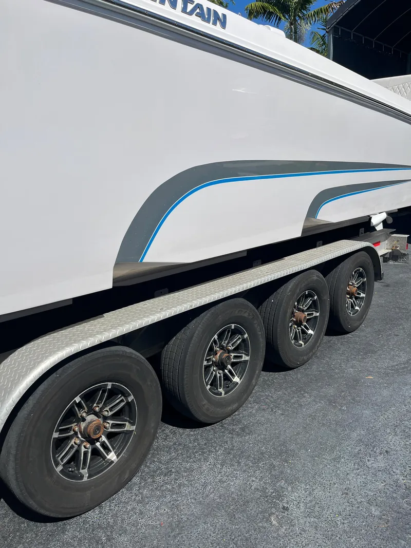 Slide: The Image of 2018 Fountain 34 CC boat on a trailer with four wheels. - 15