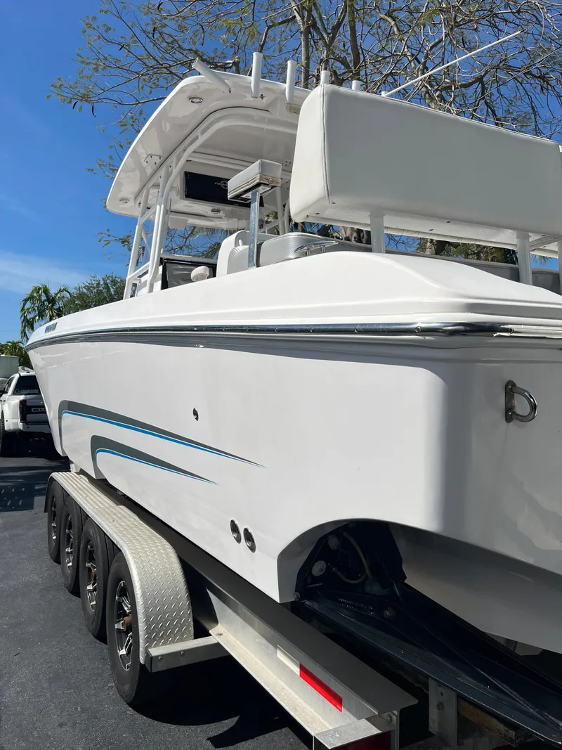 Slide: The Image of 2018 Fountain 34 CC boat on a trailer, side view. - 17