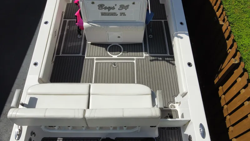 Slide: The Image of 2018 Fountain 34 CC boat interior with white seating and deck. - 20