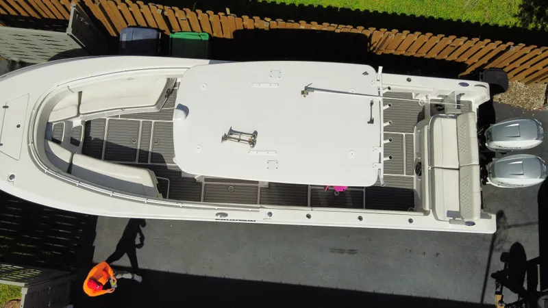Slide: The Image of Overhead view of a 2018 Fountain 34 CC boat with dual outboard motors. - 24