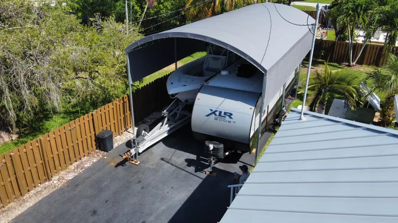 Slide: The Image of 2018 Fountain 34 CC boat under a covered storage area. - 26