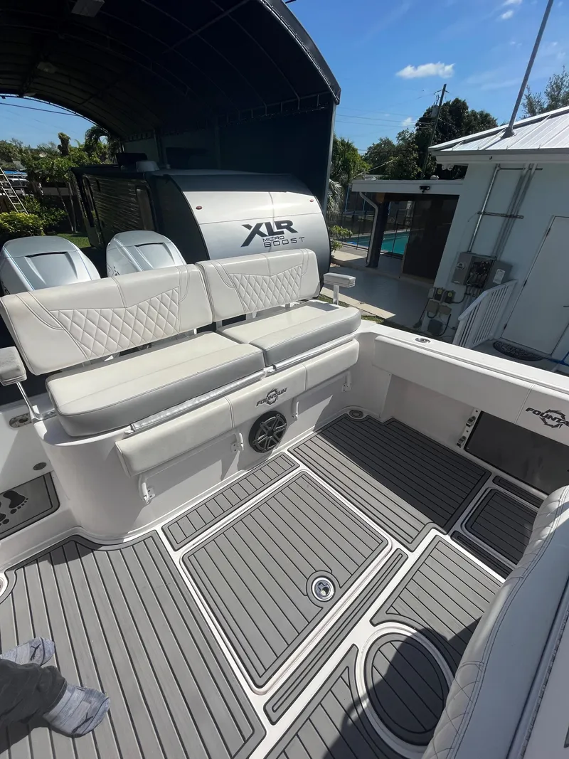 Slide: The Image of 2018 Fountain 34 CC boat with cushioned seating and XIR outboard engines. - 5
