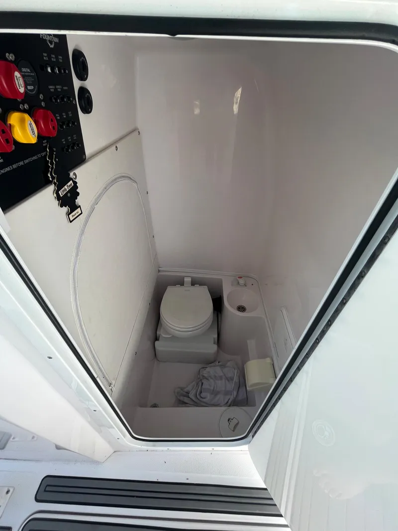 Slide: The Image of 2018 Fountain 34 CC boat interior with toilet and control panel. - 6