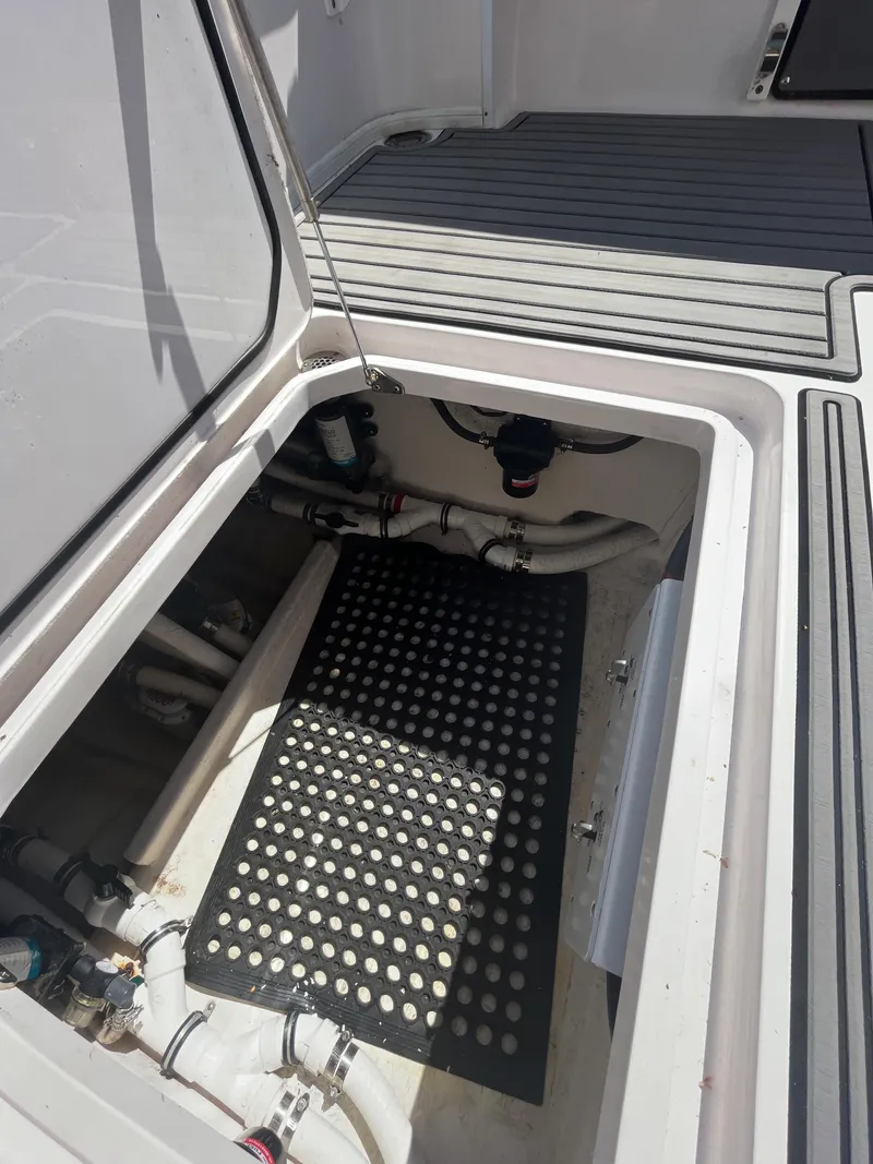 Slide: The Image of 2018 Fountain 34 CC boat storage compartment with plumbing and non-slip mat. - 8