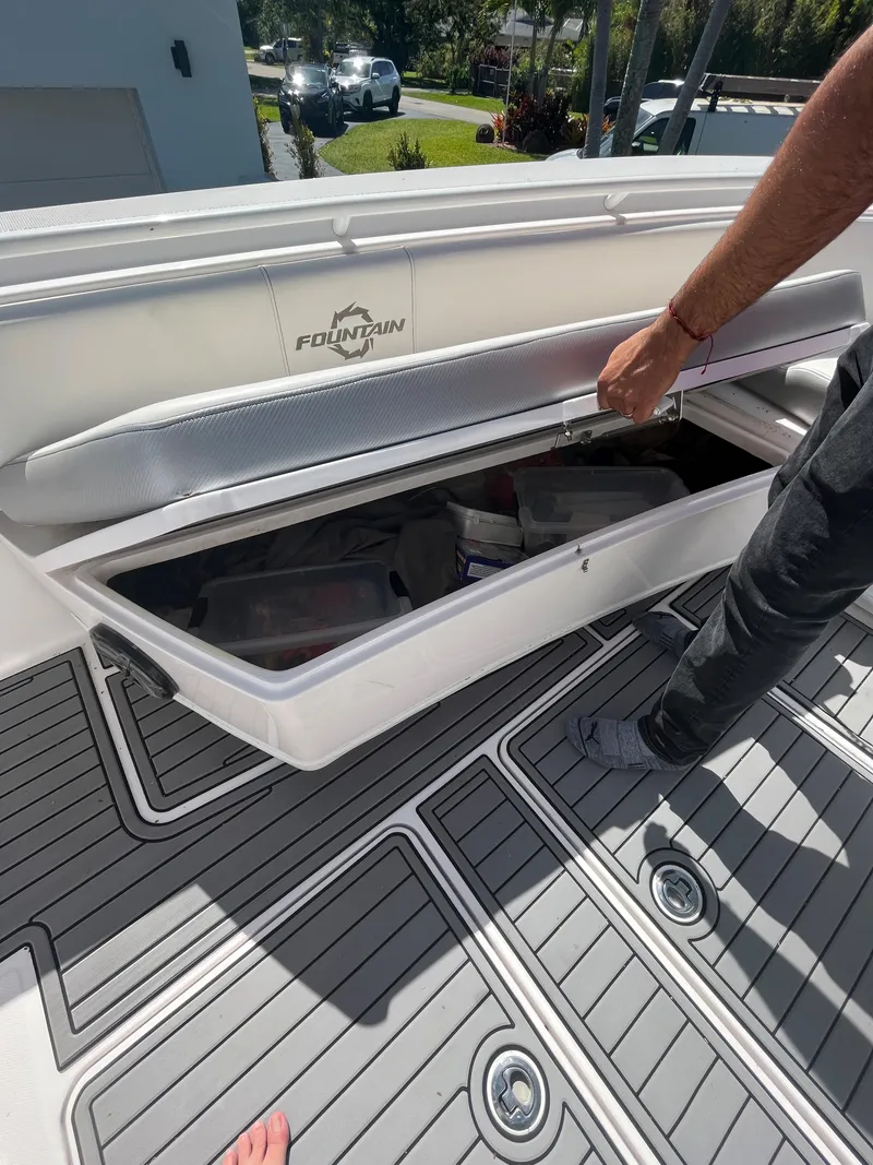 Slide: The Image of 2018 Fountain 34 CC boat storage compartment being opened on deck. - 9