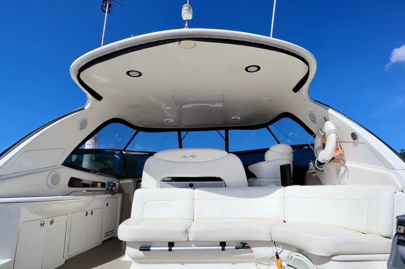 Slide: The Image of 2001 Sea Ray 460 Sundancer yacht interior with white seating and blue sky background. - 12