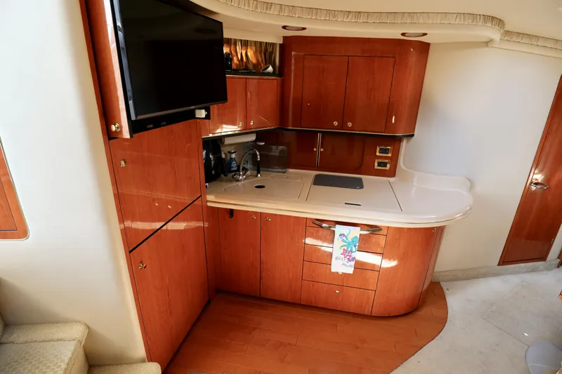 Slide: The Image of Interior of 2001 Sea Ray 460 Sundancer yacht with modern kitchen and TV. - 13