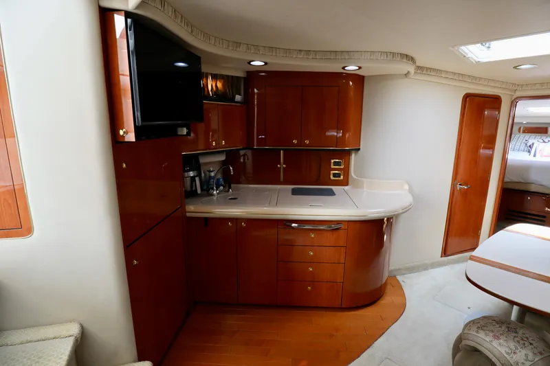 Slide: The Image of Luxurious interior of 2001 Sea Ray 460 Sundancer yacht with modern kitchen amenities. - 15