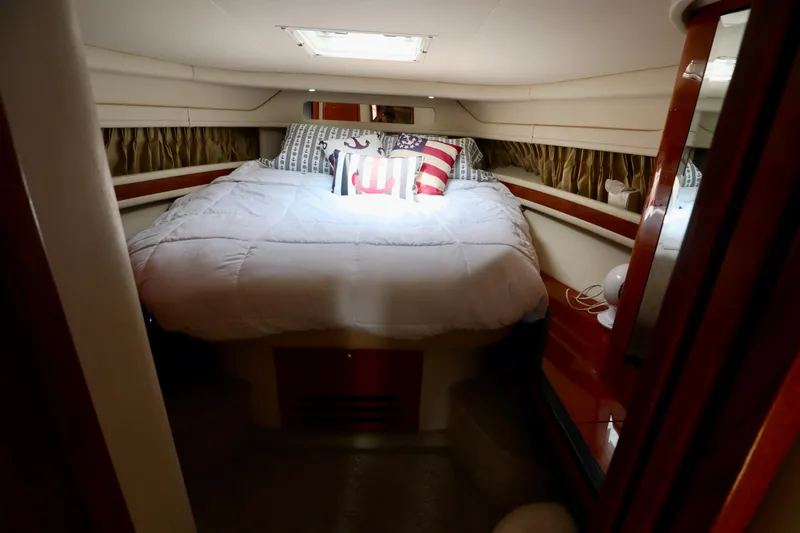 Slide: The Image of Cozy cabin interior of 2001 Sea Ray 460 Sundancer yacht with nautical-themed bedding. - 16