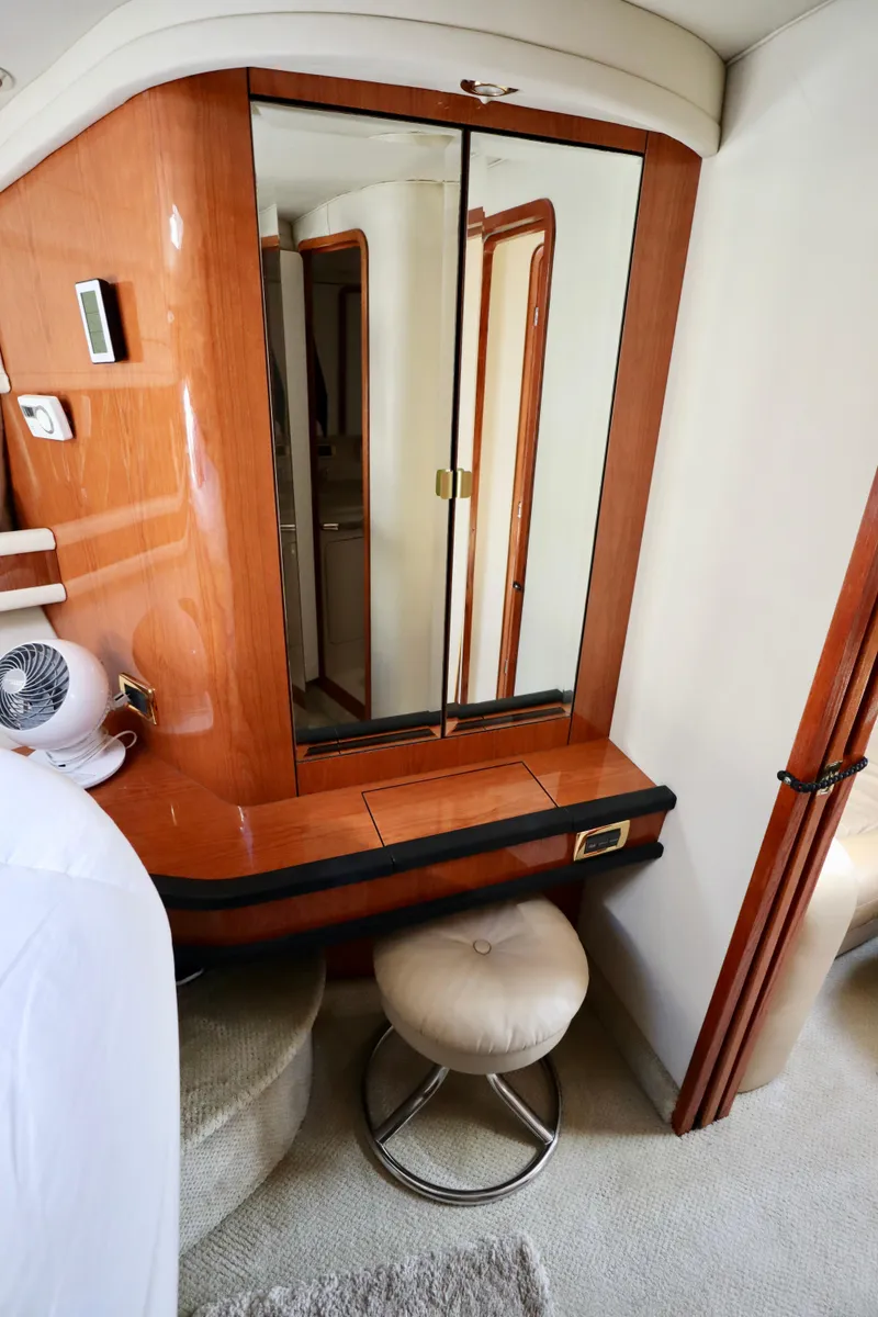 Slide: The Image of Interior of 2001 Sea Ray 460 Sundancer yacht with mirrored cabinet and stool. - 18
