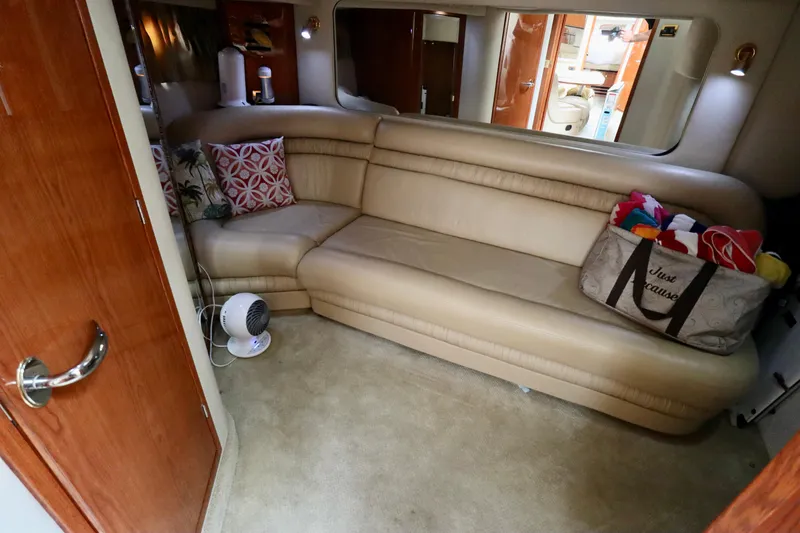Slide: The Image of Luxurious interior of 2001 Sea Ray 460 Sundancer with beige leather seating and decorative pillows. - 23