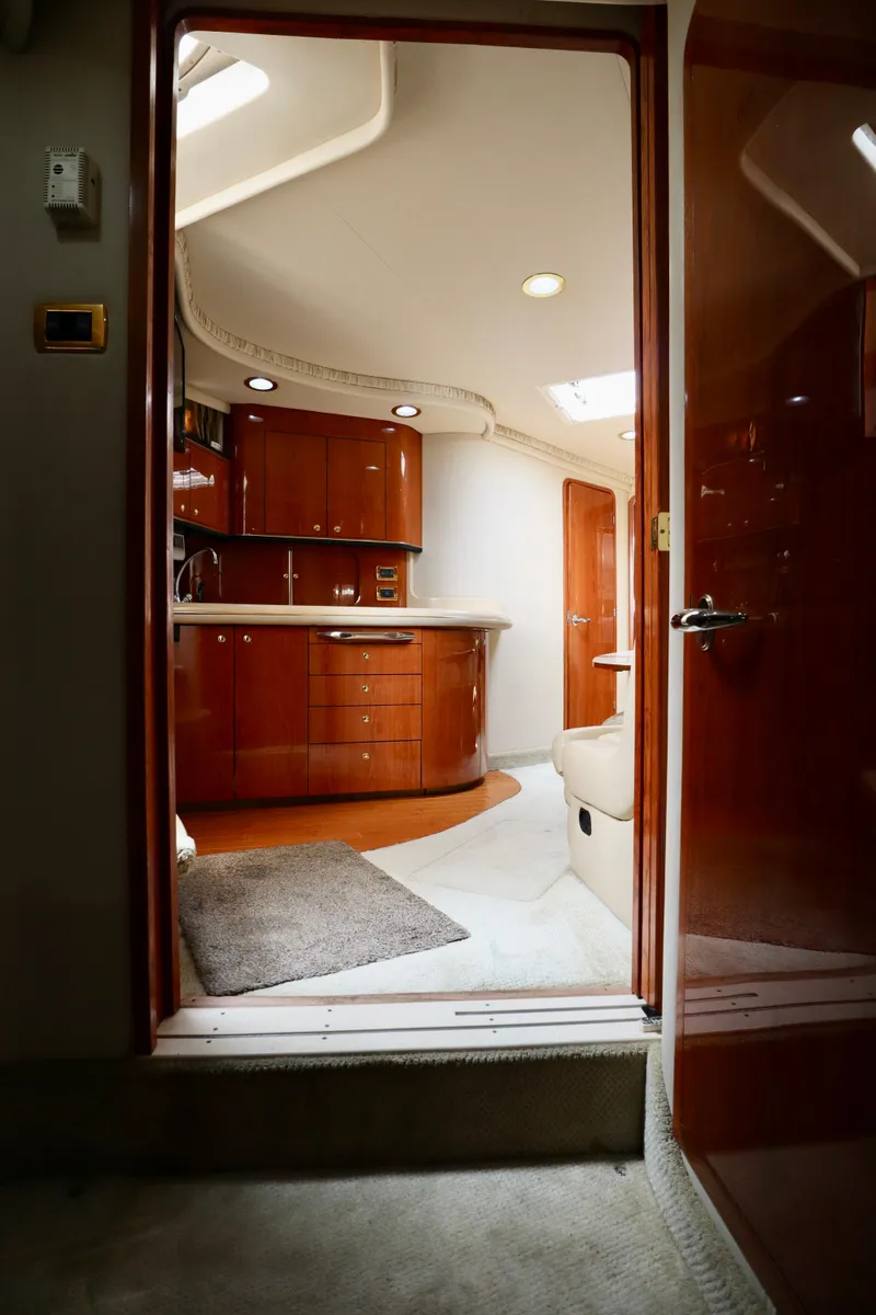Slide: The Image of Interior of 2001 Sea Ray 460 Sundancer yacht with polished wood cabinetry and modern design. - 24
