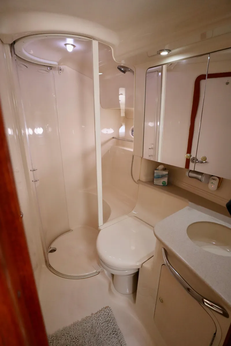 Slide: The Image of 2001 Sea Ray 460 Sundancer bathroom with shower, toilet, and vanity. - 25