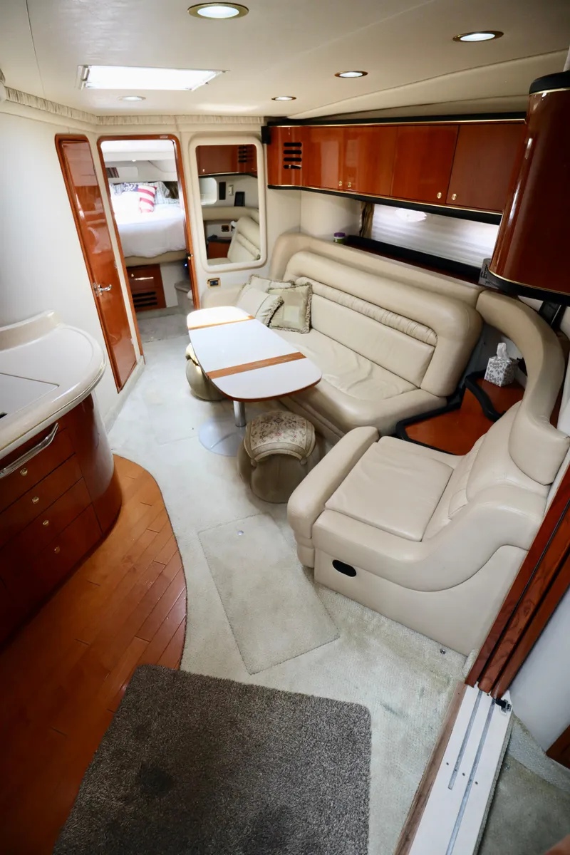 Slide: The Image of Interior of 2001 Sea Ray 460 Sundancer yacht with leather seating and wooden cabinetry. - 27