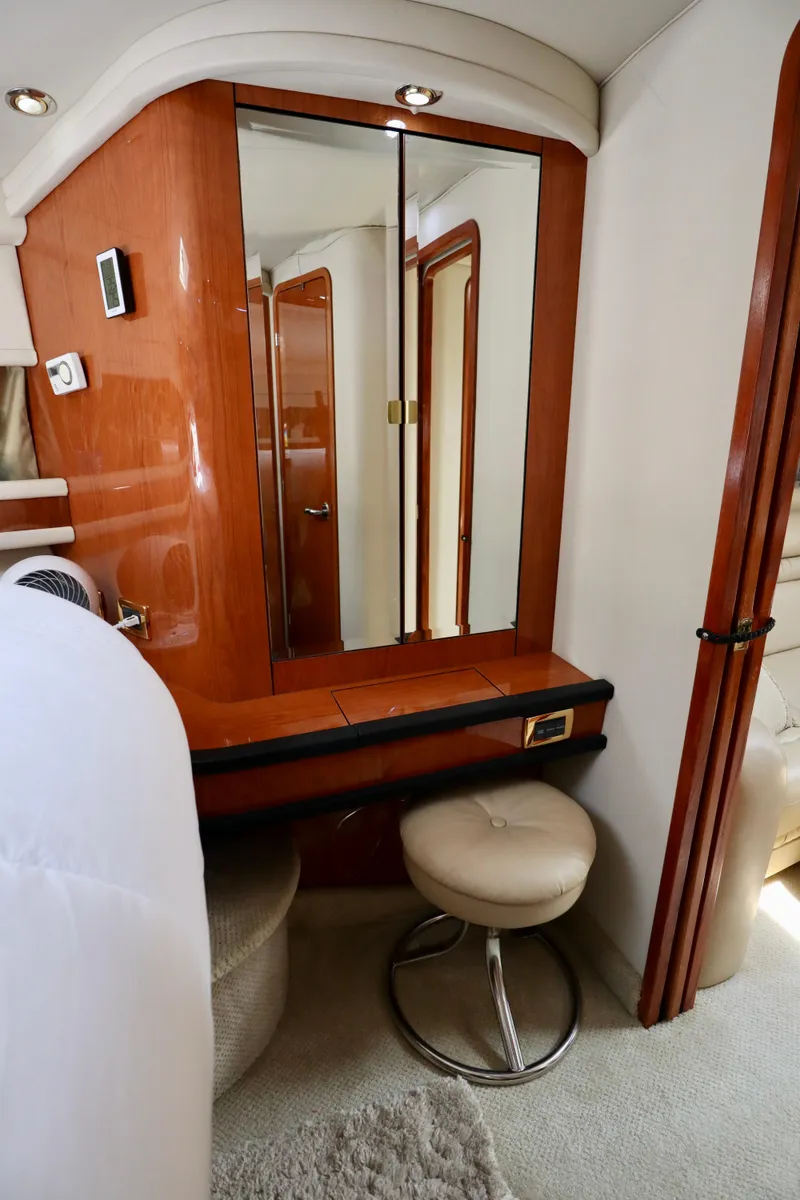 Slide: The Image of 2001 Sea Ray 460 Sundancer cabin with vanity, mirror, and stool. - 29
