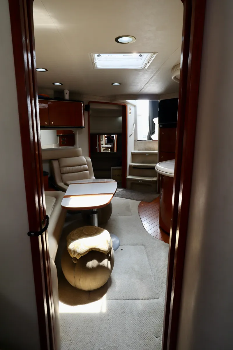 Slide: The Image of Interior of 2001 Sea Ray 460 Sundancer yacht, featuring seating and dining area. - 30