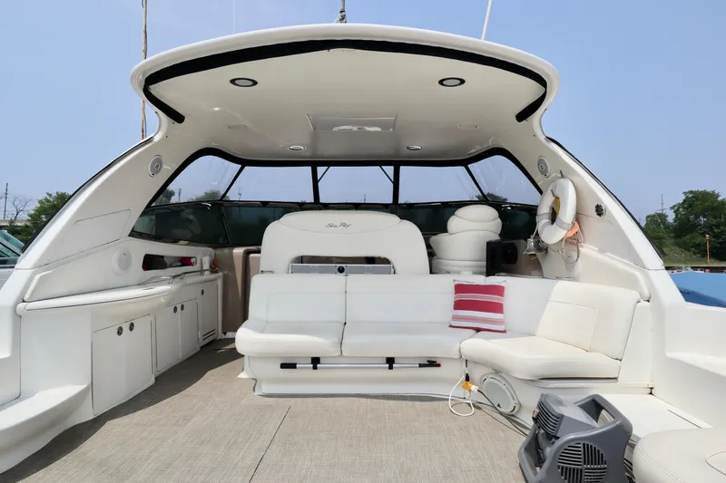 Slide: The Image of 2001 Sea Ray 460 Sundancer yacht interior with white seating and striped pillow. - 35